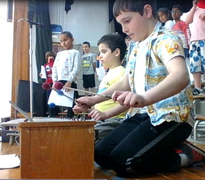 Second grade students engaging in instrument playing for their spring concert